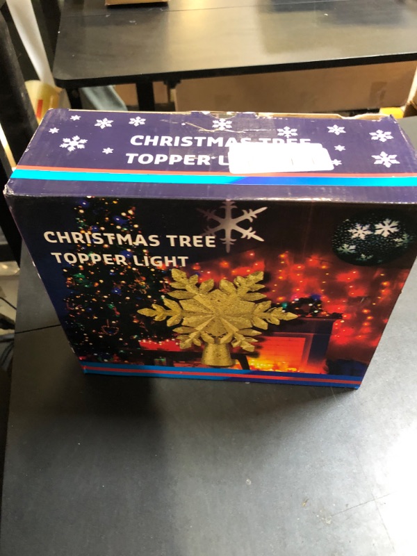 Photo 1 of OurWarm Christmas Tree Topper Lighted with LED Rotating Silver Snowflake Decorations Projector Silver Snow Tree Topper Night Light Projector for Indoor Outdoor Christmas Tree Decorations