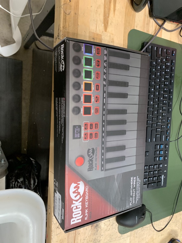 Photo 1 of RockJam, Go 25 Key USB and Bluetooth MIDI Keyboard Controller with 8 Backlit Drum Pads, 8 Knobs, One-Size (RJMK25)