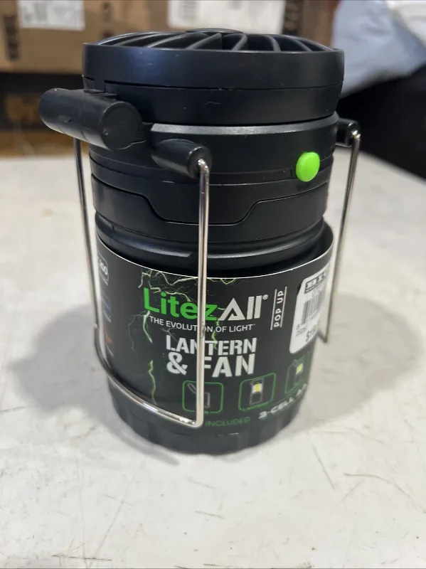Photo 1 of This Litez All Pop Up Lantern and Fan is the perfect addition to your camping or hiking trip. With its LED lighting technology, it provides bright and efficient lighting. The lantern is designed with a black plastic material and runs on battery power sour