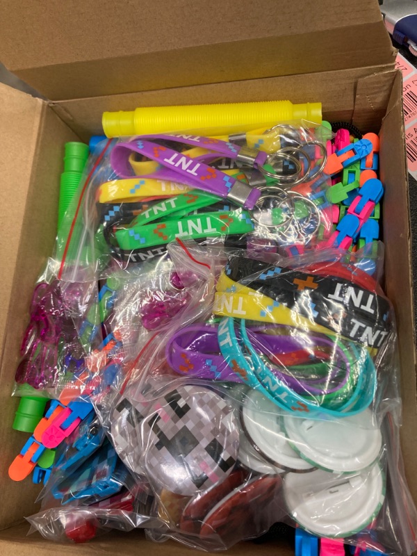 Photo 1 of 96 Pieces Pixelated Miner Party Favors Pixel Birthday Party Supplies, with Key Chains Bracelets Button Pins Sunglasses Drawstring Bags Tubes Sensory Toys Wacky Tracks Sticky Hands for Girls and Boys