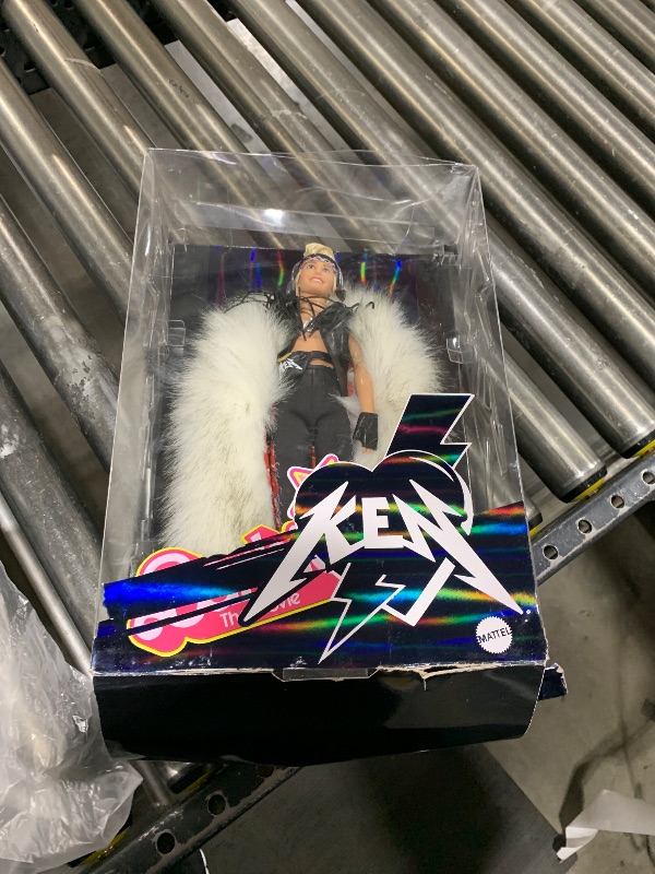 Photo 1 of Barbie The Movie Collectible Ken Doll Wearing Big Faux Fur Coat & Black Fringe Vest with Bandana (Amazon Exclusive)