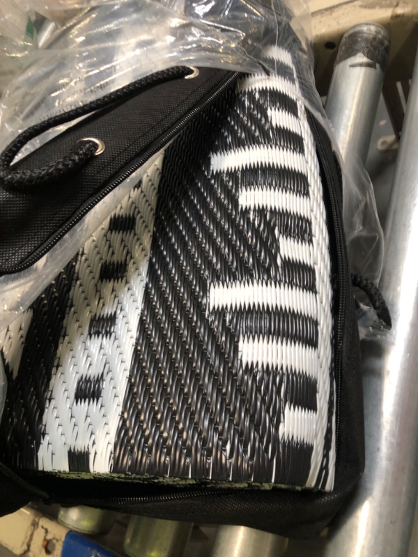 Photo 1 of OLANLY Outdoor Rug Waterproof 5x8 ft, Reversible Outdoor Plastic Straw Rug, Boho Patio Rug, Indoor Outdoor Carpet, RV Mat Outside for Patio, Camp, Picnic, Balcony, Deck, Backyard, Black & White