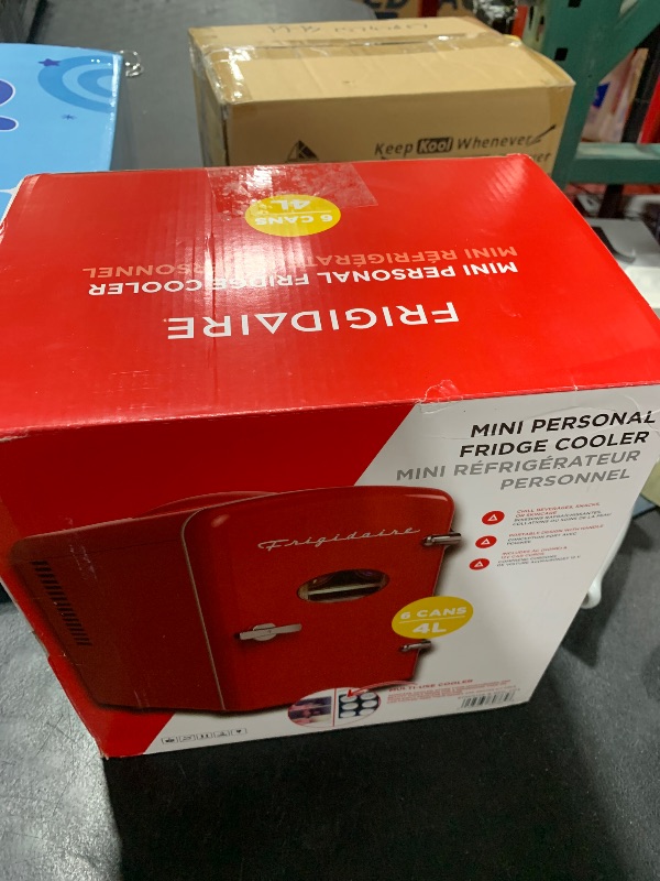 Photo 1 of Frigidaire Red Mini Personal Fridge Cooler, 1 Gal Capacity fits Six Cans, Includes Plugs for Home Outlet & DC Charger - 9.9" D x 7.1" W x 10.6" H