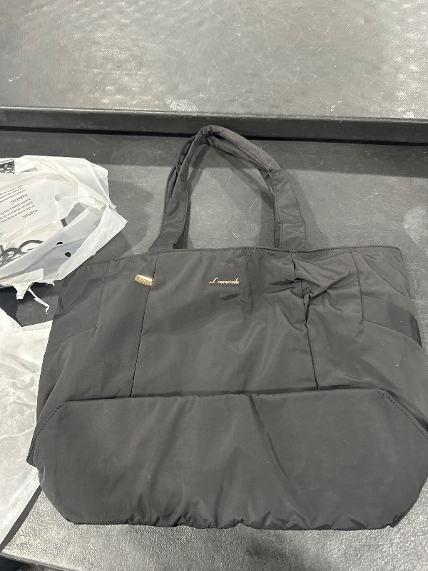 Photo 1 of black duffel bag 