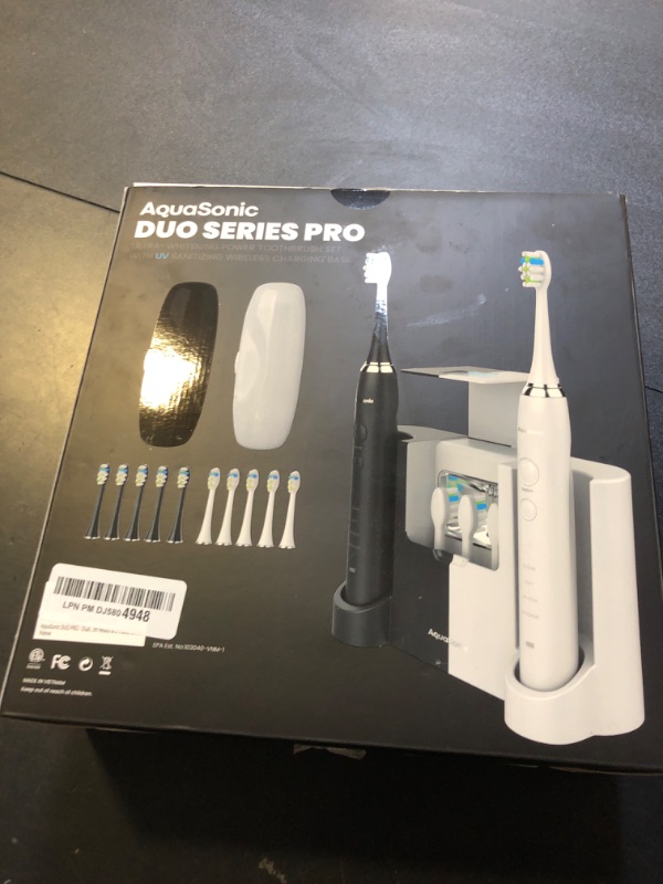 Photo 2 of AquaSonic DUO PRO – Ultra Whitening 40,000 VPM Electric ToothBrushes – ADA Accepted - 4 Modes with Smart Timers - UV Sanitizing & Wireless Charging Base - 10 ProFlex Brush Heads & 2 Travel Cases