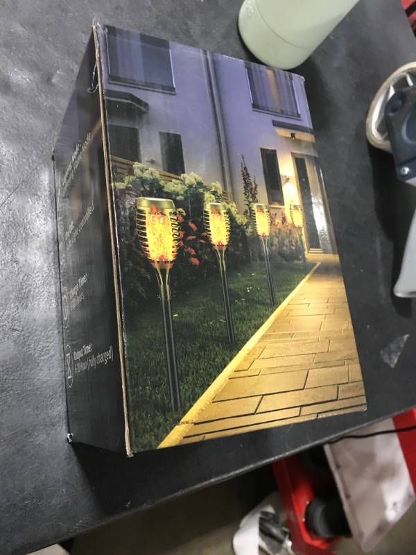 Photo 1 of Liveasily 4 Pack Led Solar Torch Light with Flickering Flame Outdoor Waterproof Halloween Decorations, Auto On/Off Solar Garden Lights