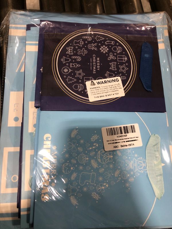 Photo 1 of 12-Pack Blue Christmas Gift Bags Assorted Sizes with Handles(4 Large 13”, 4 Medium 10.6”, 4 Small 6.7”) Snowflake, Reindeer, Tree and ‘Let it Snow’ for Gifts, Decorations, Holiday Party, 12 Pcs