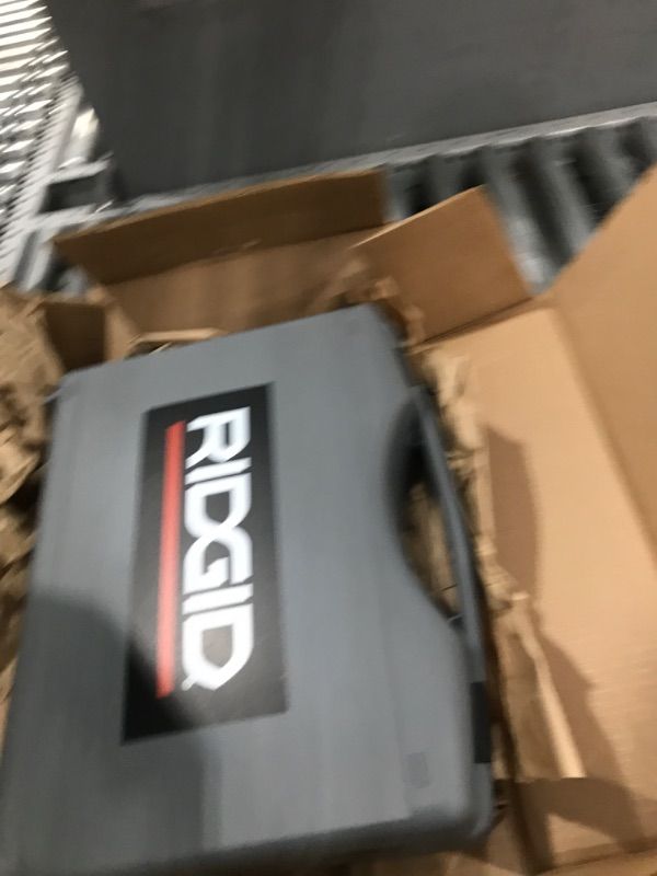 Photo 1 of RIDGID 72553 Model RP 115 Mini Press Tool and Battery Kit with 1/2" to 3/4" ProPress Press Tool Jaws, 2V Li/Ion Battery, 12V Charger, and Carrying Case , Red