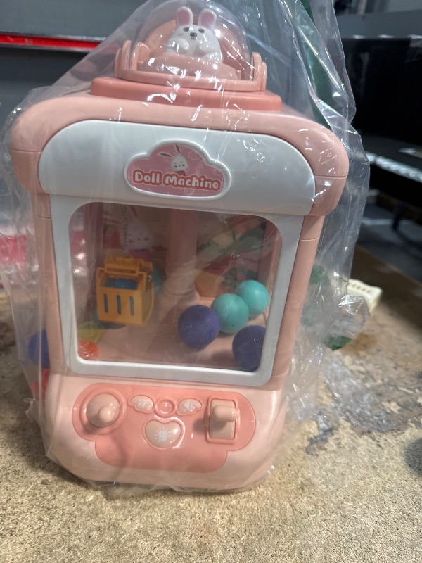 Photo 1 of Kids Claw Machine, Mini Candy Vending Grabber, Prize Dispenser Toys for Girls and Boys, Electronic Claw Game Machine for Party Birthdays with Lights Sound, Includes 10 Plush (Pink)