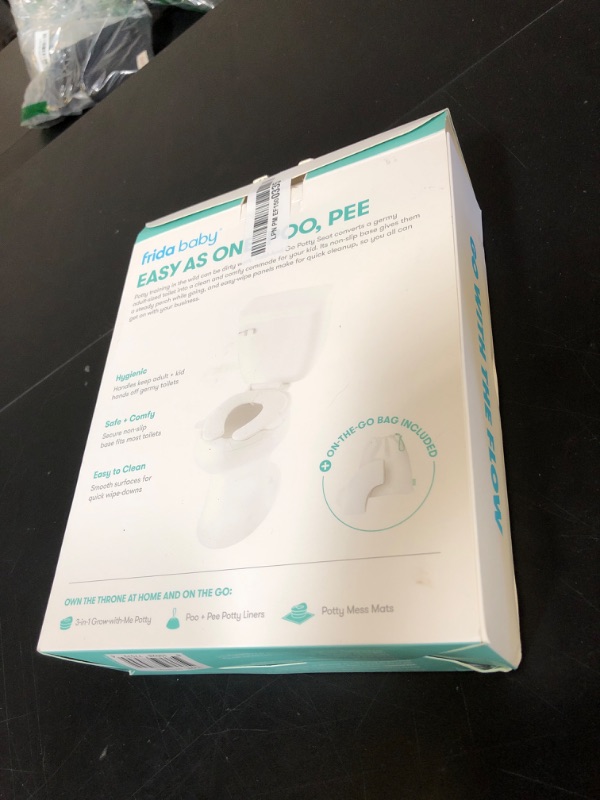 Photo 1 of Frida Baby Fold-and-Go Portable Potty Seat for Toilet, Foldable Travel Potty Seat for Toddler, Fits Round & Oval Toilets, Non-Slip Base, Handles, Includes Free Travel Bag