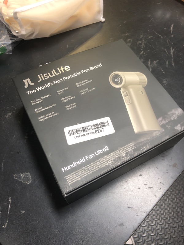Photo 1 of JISULIFE Portable Handheld Fan Ultra2, 9000mAh Max 25 Hrs, 5 IN 1, 100 Speed Turbo Fan Rechargeable 18W Power Bank with Flashlight, Metal Shell Multi-Function Travel Essentials Gifts for Men-Brown
