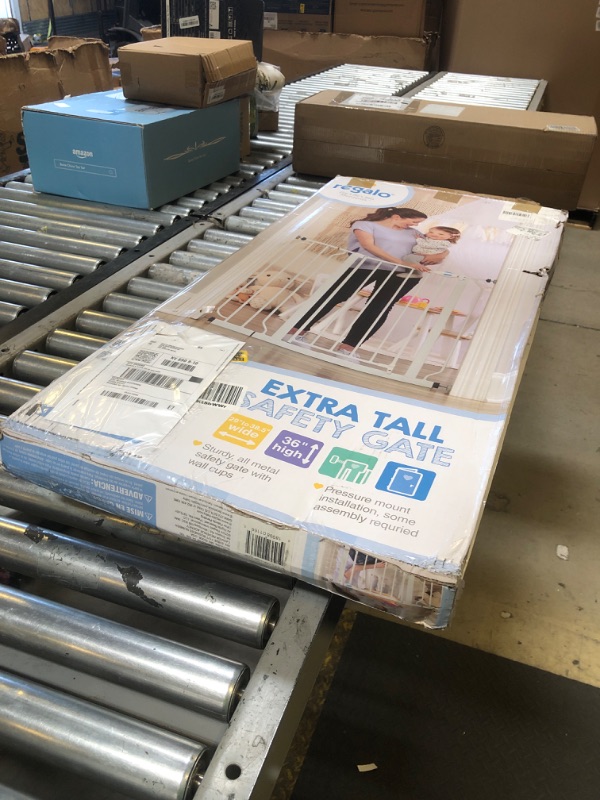 Photo 1 of Regalo Easy Step 36" Extra Tall Walk Thru Baby Gate, Includes 4-Inch Extension Kit, 4 Pack of Pressure Mount Kit and 4 Pack Wall Cups and Mounting Kit, White