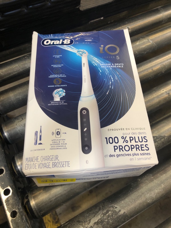 Photo 1 of Oral-B iO Series 5 Rechargeable Electric Toothbrush with Visible Pressure Sensor to Protect Gums, 2 Minute Timer, 5 Cleaning Settings, 1 Replacement Toothbrush Heads, and Travel Case, White