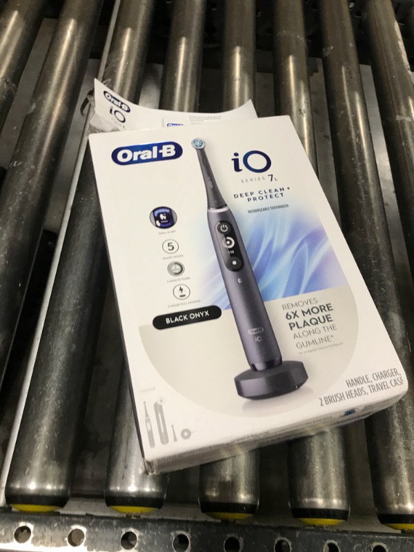 Photo 1 of Oral-B iO Deep Clean + Protect Rechargeable Electric Toothbrush, Black with a iO Series 7 Toothbrush, 2 Replacement Brush Heads, and a Charging Travel Case