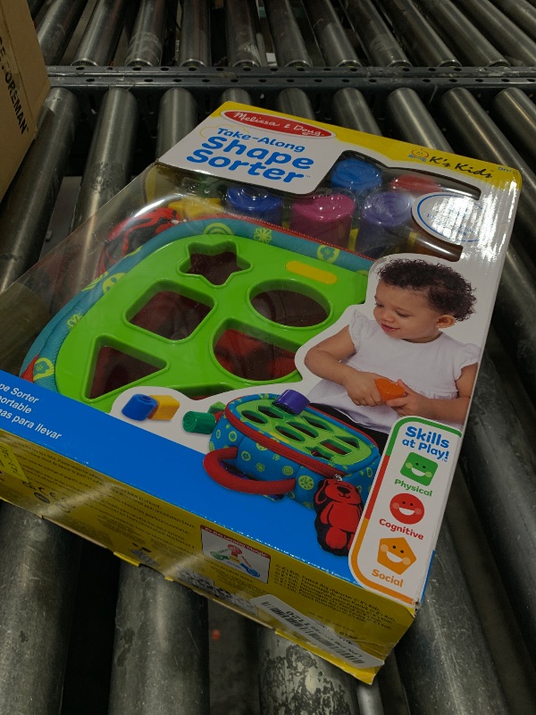 Photo 1 of Melissa & Doug K's Kids Take-Along Shape Sorter Baby Toy with 2-Sided Activity Bag and 9 Textured Shape Blocks