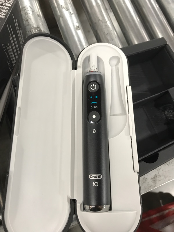 Photo 1 of Oral-B iO Series 10 Rechargeable Electric Toothbrush with Visible Pressure Sensor to Protect Gums, 2 Min Timer, 7 Cleaning Settings, 4 Replacement Toothbrush Heads, and Charging Travel Case, Black
