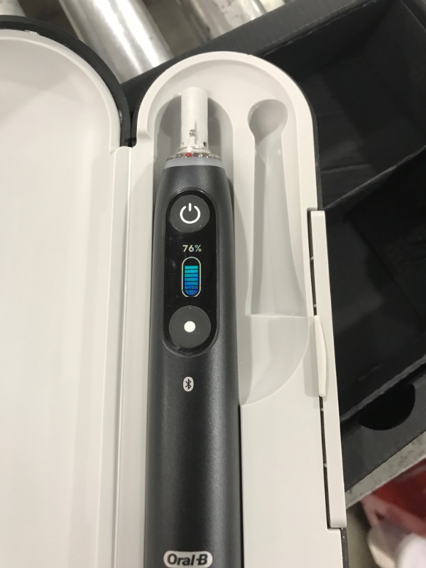Photo 1 of Oral-B iO Series 10 Rechargeable Electric Toothbrush with Visible Pressure Sensor to Protect Gums, 2 Min Timer, 7 Cleaning Settings, 4 Replacement Toothbrush Heads, and Charging Travel Case, Black