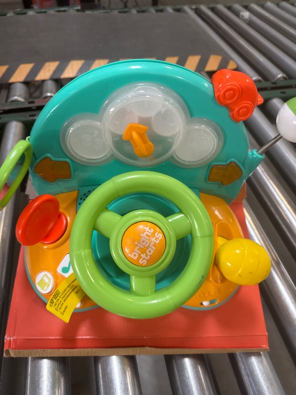 Photo 1 of Bright Starts Lights and Colors Driver Steering Wheel Toy with Car Sounds for Pretend Play, 50+ Songs & Sounds, Baby Toy for Tummy Time 6 Months and up
