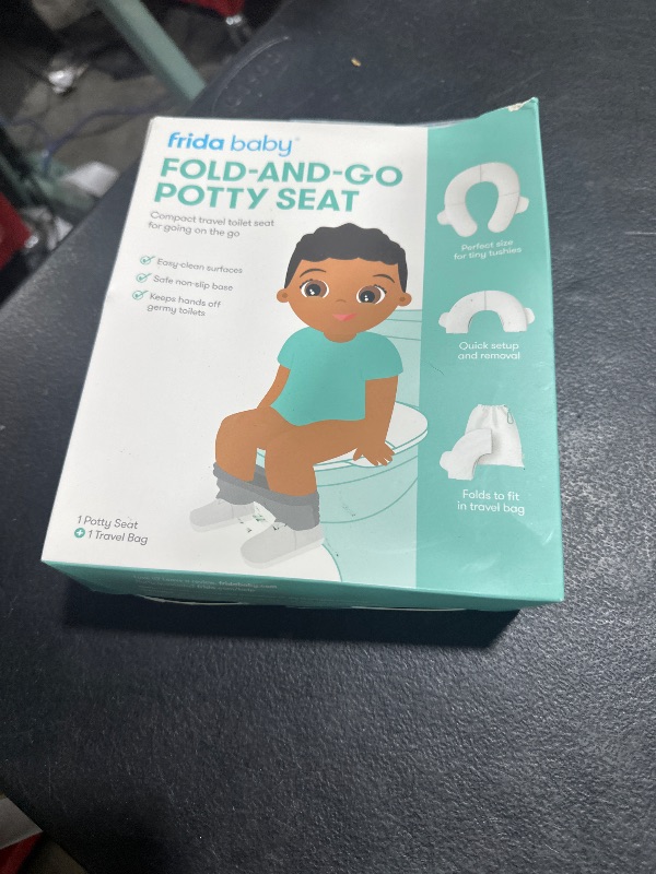 Photo 1 of Frida Baby Fold-and-Go Portable Potty Seat for Toilet, Foldable Travel Potty Seat for Toddler, Fits Round & Oval Toilets, Non-Slip Base, Handles, Includes Free Travel Bag