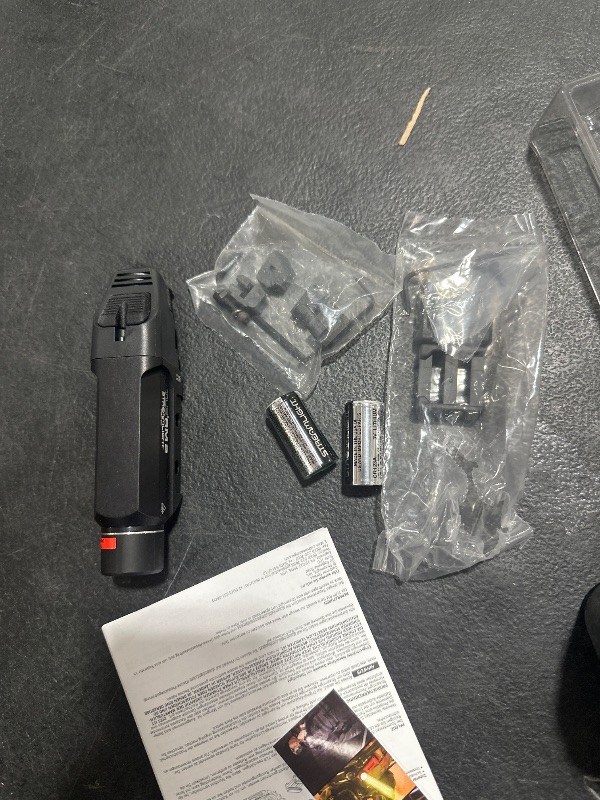 Photo 1 of Streamlight 69450 TLR RM 2 Compact, Portable Rail-Mounted LED Tactical Lighting System with Tail Loc, Remote Switch, and 2 Lithium Batteries, Black