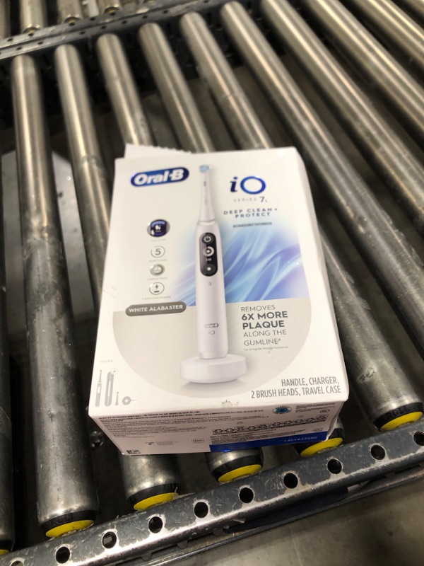 Photo 1 of Oral-B iO Deep Clean + Protect Rechargeable Electric Toothbrush, White with a iO Series 7 Toothbrush, 2 Replacement Brush Heads, and a Charging Travel Case