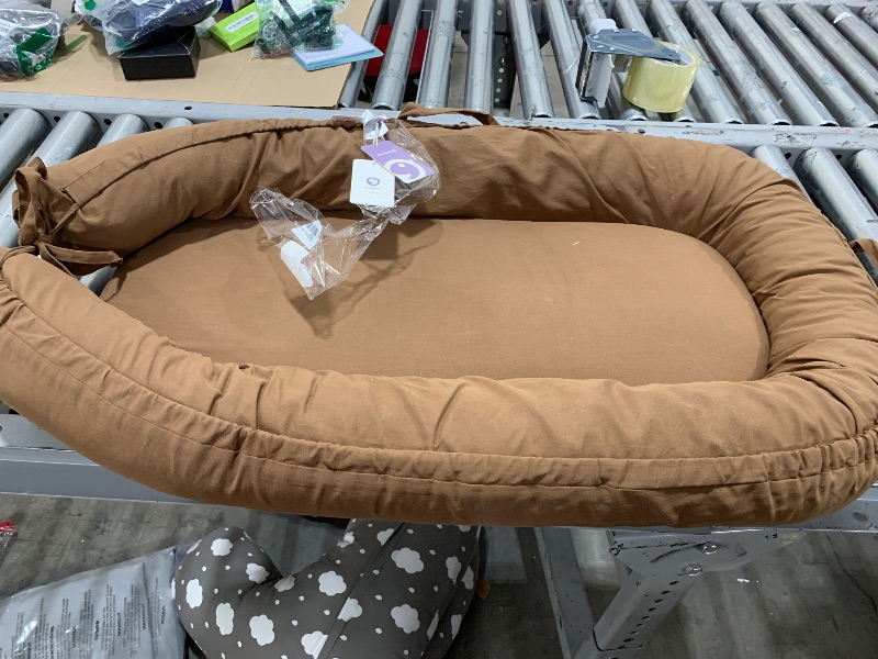 Photo 1 of CooCooBaby Infant Lounger, Baby Nest Cover for Baby Girls & Boys, Newborn Essentials for Baby 0-12 Months, 100% Cotton Breathable, Portable Travel Bed (Golden_Brown)