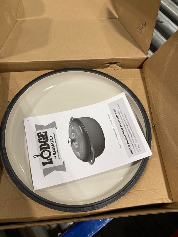 Photo 1 of **chipped**
Lodge 6 Quart Enameled Cast Iron Dutch Oven with Lid – Dual Handles – Oven Safe up to 500° F or on Stovetop - Use to Marinate, Cook, Bake, Refrigerate and Serve – Oyster White