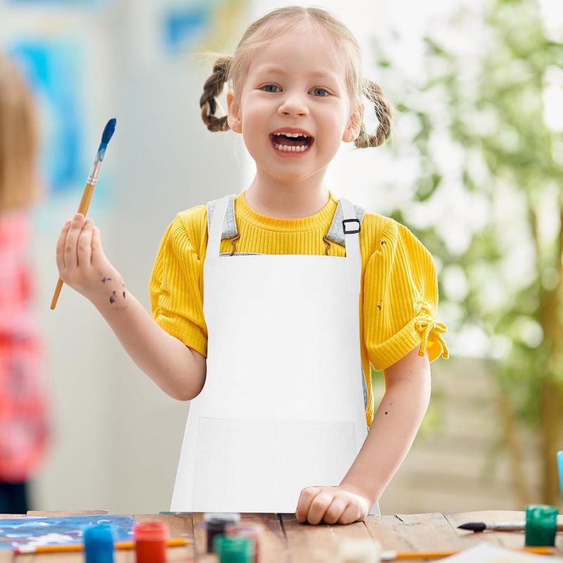 Photo 1 of Bouiexye   Kids Apron Adjustable Children Apron with 2 Pockets Children Chef Painting Aprons for Cooking Baking Painting Crafts Making (White)