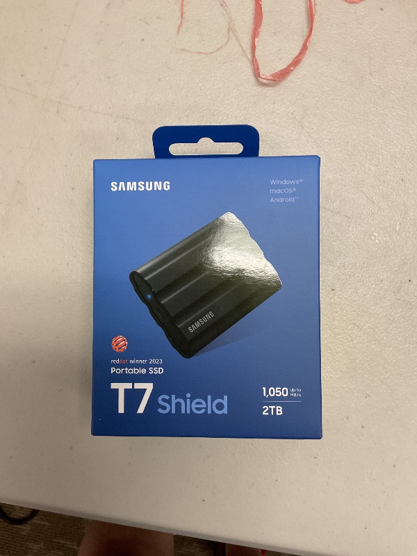 Photo 1 of Samsung T7 Shield 2TB, Portable SSD, up-to 1050MB/s, USB 3.2 Gen2, Rugged,IP65 Water & Dust Resistant, for Photographers, Content Creators and Gaming, Extenal Solid State Drive (MU-PE2T0S/AM), Black