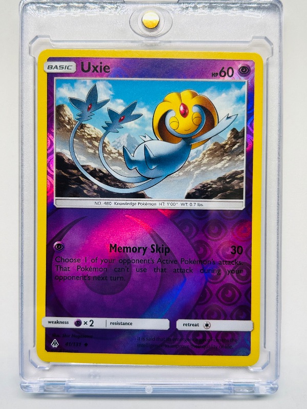 Photo 1 of 165040… Pokémon reverse holo Uxie card in hard plastic case 