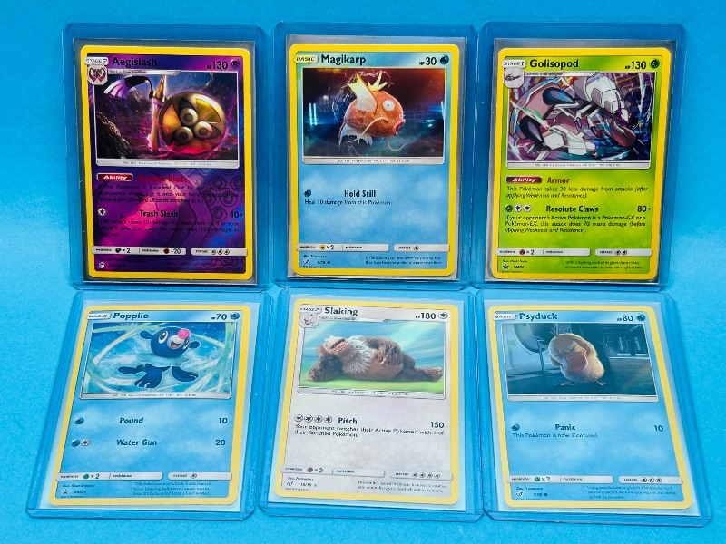 Photo 1 of 165303…6 holo and reverse holo Pokémon cards in hard plastic sleeves