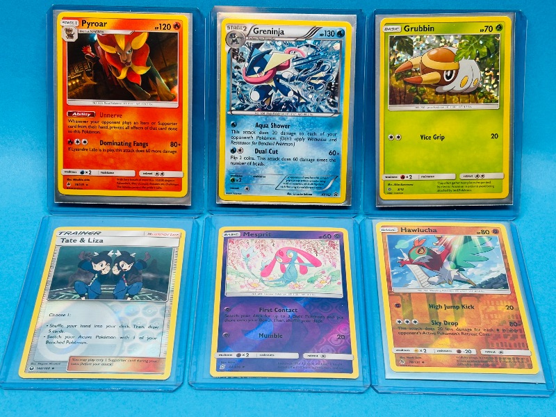 Photo 1 of 165418…6 holo and reverse Pokémon cards in hard plastic sleeves 