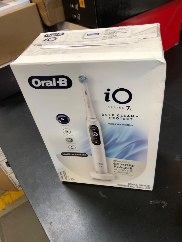 Photo 1 of Oral-B iO Deep Clean + Protect Rechargeable Electric Toothbrush, White with a iO Series 7 Toothbrush, 2 Replacement Brush Heads, and a Charging Travel Case