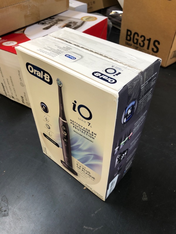 Photo 1 of Oral-B iO Deep Clean + Protect Rechargeable Electric Toothbrush, Black with a iO Series 7 Toothbrush, 2 Replacement Brush Heads, and a Charging Travel Case