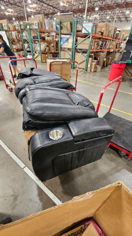 Photo 1 of ***TRUCK OR TRAILER PICK UP****BROKEN DAMAGED******PARTIAL SET****Signature Design by Ashley Caveman Den Modern Faux Leather Power Reclining Sofa with Adjustable Headrest, Drop Down Table, Electrical Outlets and LED Reading Lights, Black