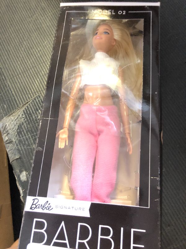 Photo 1 of Barbie Basics Model 02 Collector Doll with Blonde Hair, Black Mini Dress & Gladiator Boots, Universal-fit Fashions, Posable Body & Swappable Doll Head