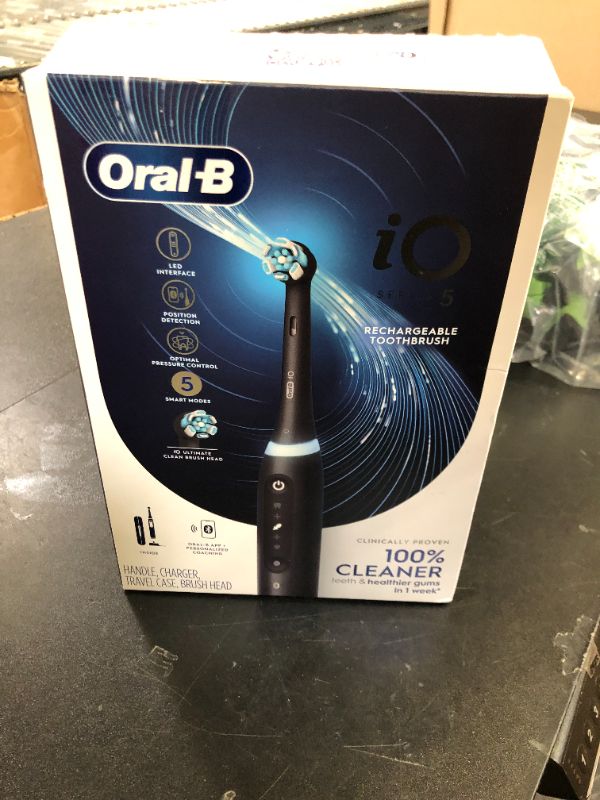 Photo 1 of Oral-B iO Series 5 Rechargeable Electric Toothbrush with Visible Pressure Sensor to Protect Gums, 2 Minute Timer, 5 Cleaning Settings, 1 Replacement Toothbrush Heads, and Travel Case, Black