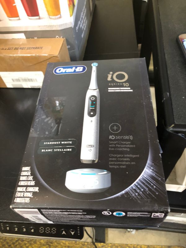 Photo 1 of Oral-B iO Series 10 Rechargeable Electric Toothbrush with Visible Pressure Sensor to Protect Gums, 2 Min Timer, 7 Cleaning Settings, 4 Replacement Toothbrush Heads, and Charging Travel Case, White