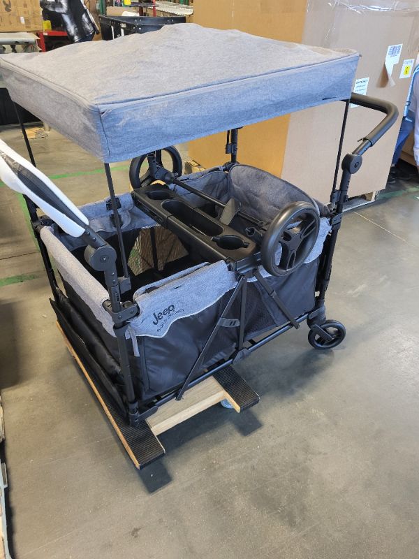 Photo 1 of ***conector to cheels missing***
Jeep Wrangler Deluxe 4 Seater Stroller Wagon by Delta Children - Premium Quad Stroller Wagon for 4 Kids with Convertible Seats, Adjustable Push/Pull Handles, Removable Canopy & Flat Fold, Grey