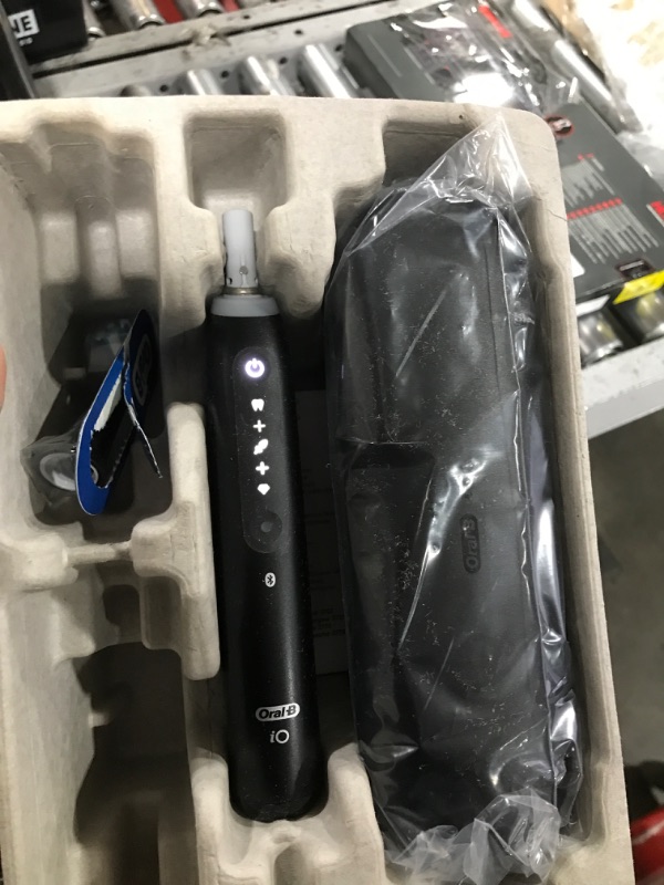 Photo 1 of Oral-B iO Series 5 Rechargeable Electric Toothbrush with Visible Pressure Sensor to Protect Gums, 2 Minute Timer, 5 Cleaning Settings, 1 Replacement Toothbrush Heads, and Travel Case, Black