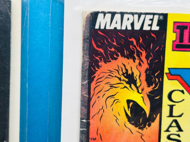 Photo 1 of 025312…damaged comics in plastic sleeves- bent, wear