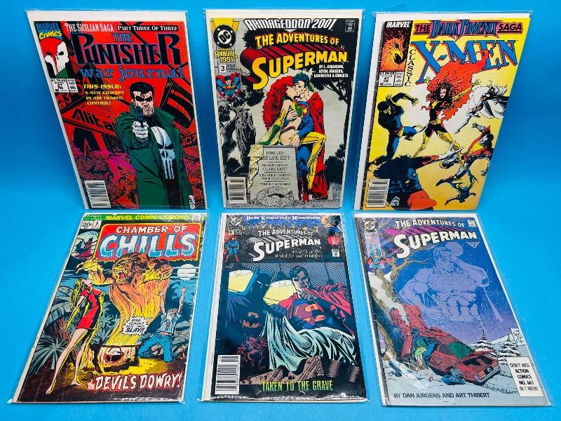Photo 1 of 025312…damaged comics in plastic sleeves- bent, wear