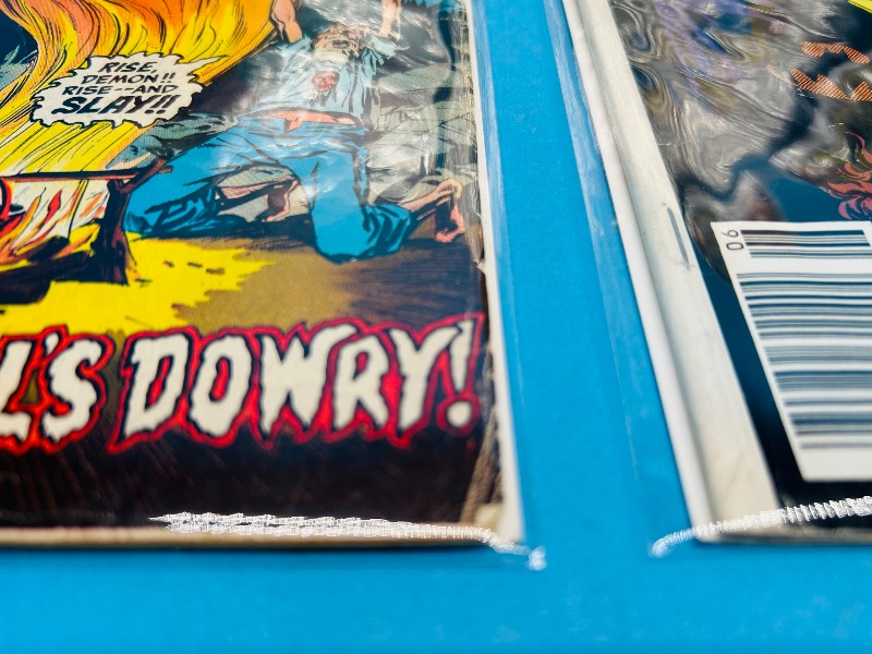 Photo 1 of 025312…damaged comics in plastic sleeves- bent, wear