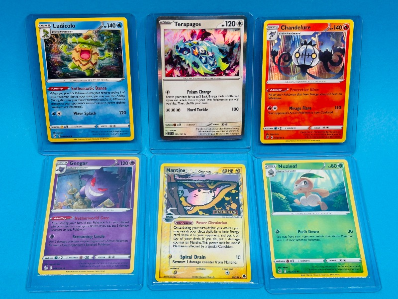 Photo 1 of 025758… 6 holo Pokémon cards in hard plastic sleeves