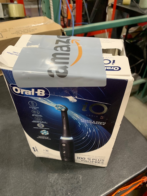 Photo 1 of Oral-B iO Series 5 Rechargeable Electric Toothbrush with Visible Pressure Sensor to Protect Gums, 2 Minute Timer, 5 Cleaning Settings, 1 Replacement Toothbrush Heads, and Travel Case, Black