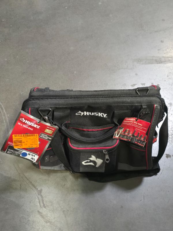 Photo 1 of Husky 18 in. Tech Tool Bag - Dimensions: 11 in. x 18 in. x 13 in. -Water-resistant 1680 denier material to withstand tough condition -
Five heavy-duty feet protect the base
