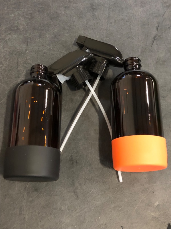 Photo 1 of Glass Spray Bottle with Silicone Sleeve Protection, Amber Glass Spray Bottle Set for Non-toxic Window Cleaner Aromatherapy Facial Hydration Watering Flowers Hair Care 2 Pack/16 oz (Black & Orange)