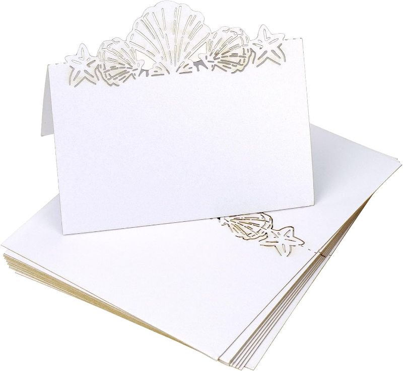 Photo 1 of Set of 50 Nautical Place Cards for Table Setting, Seashell and Starfish Cutout Name Cards for Beach Wedding Party Shower, White
