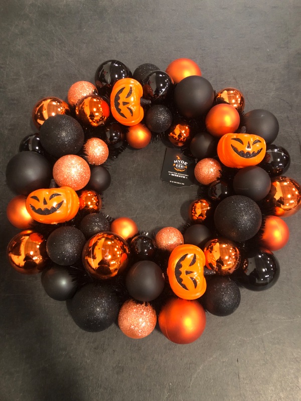 Photo 1 of Hyde and EEK Halloween Wreath with Pumpkin Baubles, featuring Black and Orange Shatterproof Bulbs and Pumpkin Shaped Ornaments 