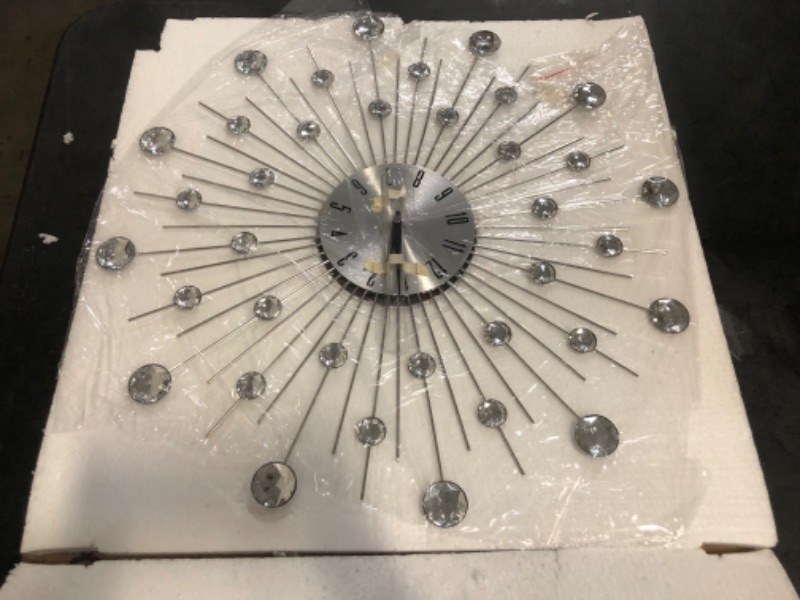 Photo 1 of Deco 79 Metal Starburst Decorative Wall Clock With Crystal Accents for Home and Room, 15" x 2" x 15", Silver